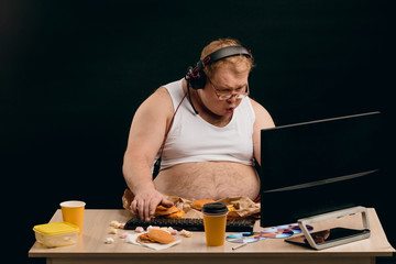 emotional gamer looking at the display. man leadins unhealthy lifestyle. gaming, entertainment concepts © alfa27