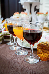 glass goblets with red and orange juice