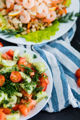 Delicious dishes and salads on the table, close-up