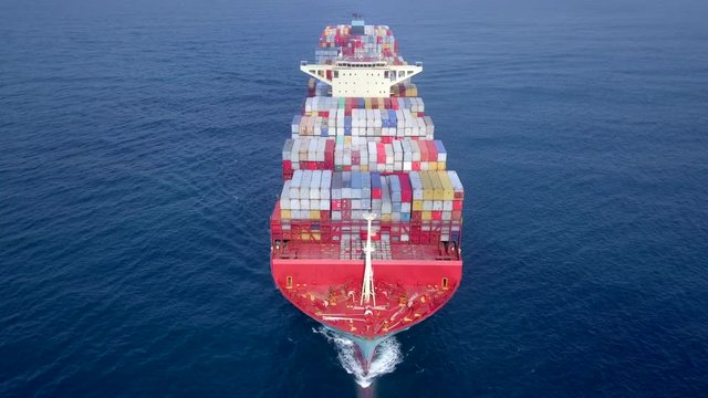 Ultra large container vessel (ULCV 366 Meters long) loaded with various Container brands, at sea - Aerial footage.