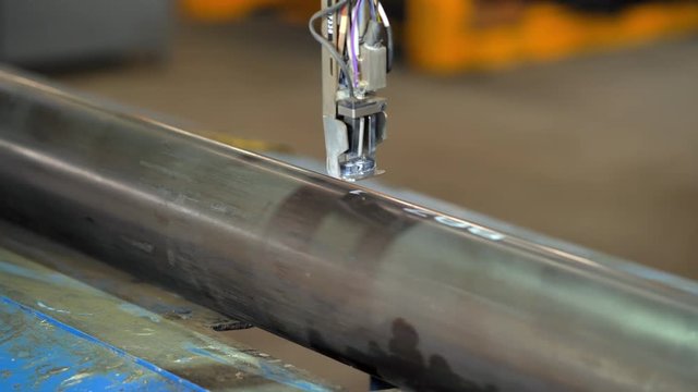 Laser marking machine powder paint engraving. Manufacturing of metal pipes of the plant. The process of manufacturing metal pipes on the machine.