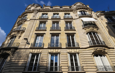 Obraz premium Traditional French house with typical balconies and windows. Paris.