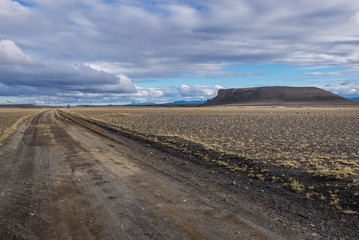 Fototapeta na wymiar Road to Hrossaborg - Horse Castle - tephra and scoria crater near Route 1 in northeast part of Iceland