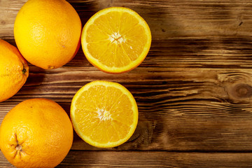 Fototapeta na wymiar Fresh oranges on wooden table