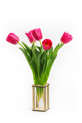 bouquet of tulips in the original wooden vase. Isolated on white background.