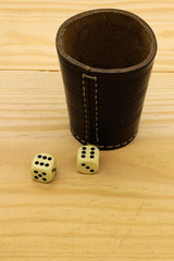 A dice shaker with dices, isolated