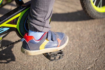 Obraz premium child on a bicycle at asphalt road. Bike in the park moving