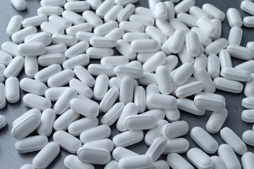 Fototapeta na wymiar Potassium gluconate tablets on a gray background