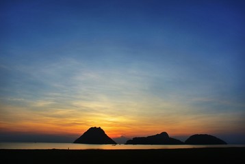 The most romantic sunrise.Silhouette sea mountains and sun