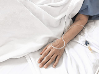 Obraz na płótnie Canvas Patient receiving treatment, iv fluid intravenous drop saline drip in hospital room. Cancer. Chemotherapy