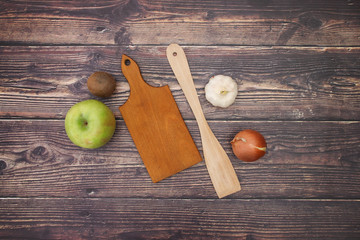 Cutting board and wooden spoon with fruits and vegetables for vegetarian