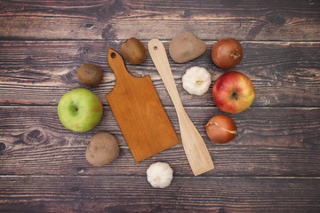 Cutting board and wooden spoon with fruits and vegetables for vegetarian