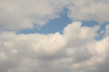 Obraz premium White clouds against the blue sky.