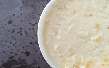 Top close view of a container of pineapple cottage cheese on a gray table