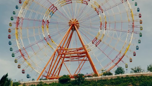 Design Layout or template for video editing. Mockup. A huge ferris wheel on a background of blue sky.
