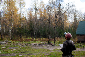 Male tourist exploring new places. Handsome bearded man on nature with fuel. Using drone photographs and shoots nature