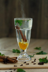 Cup of hot vitamin tea on wooden table. winter hot seasonal drinks
