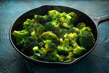 Fried broccoli in cast iron skillet, frying pan
