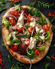 Roasted Duck kebab on flat bread with yogurt dip and salad