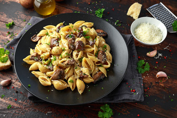 Carbonara mushrooms pasta Conchiglie with creamy sauce, parmesan cheese and herbs