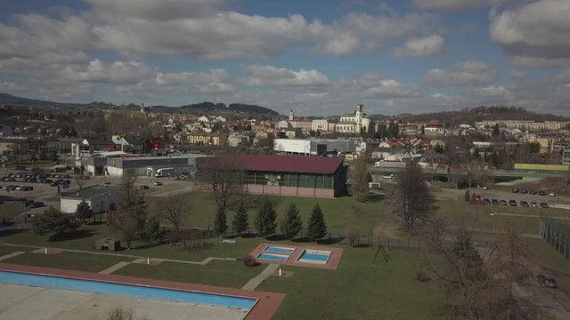 Gorlice, Poland - 3 9 2019: Panorama of the historic center of the European medieval city on the picturesque green hills. Trips to architectural monuments, temples, quarters and sports complex MOSiR