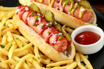 frankfurter Sausage hotdogs with french potato fries, chips. crinkle cut gherkins, ketchup and...