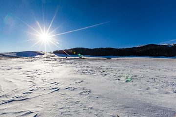 The frozen Sailimu lake with snow mountain background at Yili, Xinjiang of China