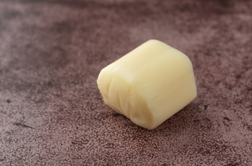 Small piece of mozzarella string cheese on a red background