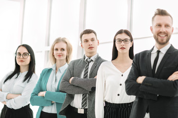 business team standing in a row in a bright office