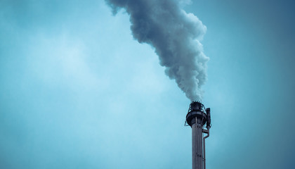 smoke from chimney at the factory against the gray sky
