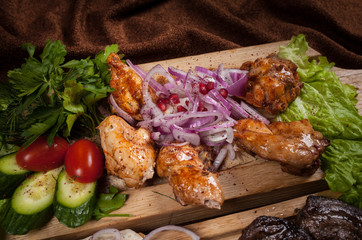 Grilled meat on a wooden Board with vegetables