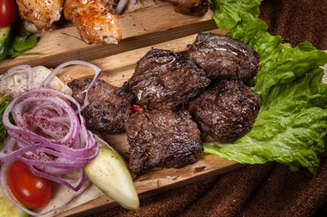 Grilled meat on a wooden Board with vegetables