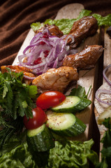Grilled meat on a wooden Board with vegetables