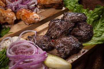 Grilled meat on a wooden Board with vegetables