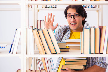 Male student preparing for exams at library 