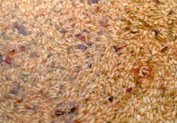 Mexican rice and beans mix in a skillet with water added side view