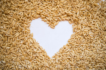 Oat grains  in the shape of a heart with a place for designers. The concept of love of oat