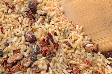 Dry Mexican rice and beans mix with a wood spoon in the food