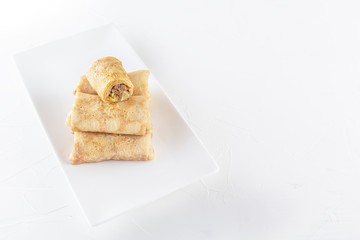 Chinese tortillas - bings in plate on a white background. Copy space