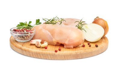 Cutting board with raw chicken fillet and spices for cooking meat on white.