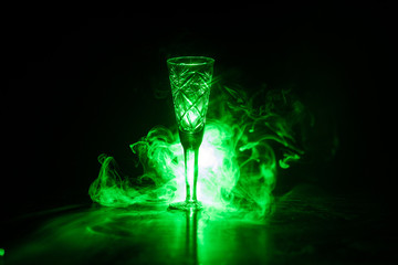 Closeup wine glass with fog at dark background. Beautiful glass with smoke and light.