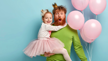 My best dad ever. Cheerful small child on fathers hands, embraces him with love, play together....