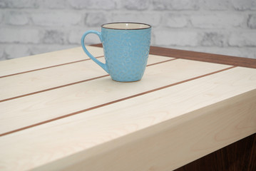 blue mug standing on a wooden table
