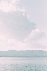 Sunset on the lake, the water surface as a mirror. Evening nature, colors of Italy.  landscape