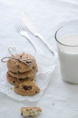 Oatmeal cookies and a glass of milk on a kitchen table. Morning snack concept