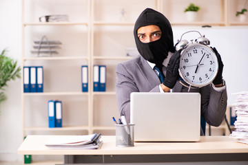 Male gangster stealing information from the office  © Elnur