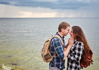 Couple tourists with backpacks outdoors.