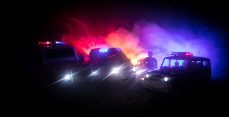 Obraz na płótnie Canvas Police cars at night. Police car chasing a car at night with fog background. 911 Emergency response pSelective focus