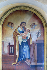 Saint Joseph holding child Jesus, altar of Saint Joseph in the church of Holy Trinity in the...
