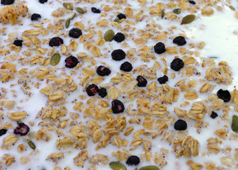 Organic breakfast cereal with milk plus dried blueberries and pumpkin seeds.